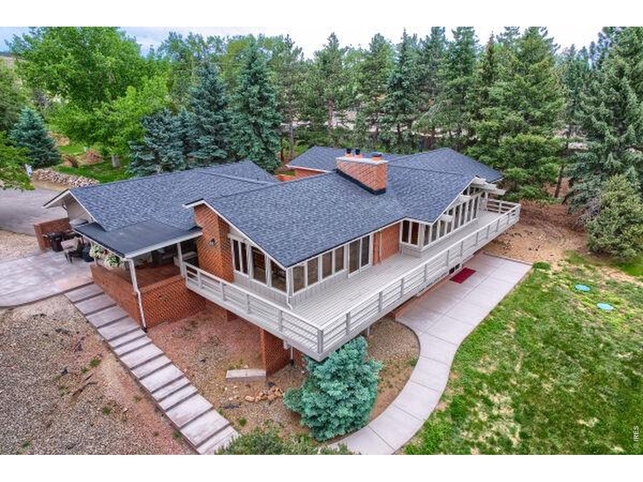 19 Ridge Road Boulder, CO 80303 - Photo 4 of 49 Back view showing walls of windows facing west, walkout basement, deck and patio
