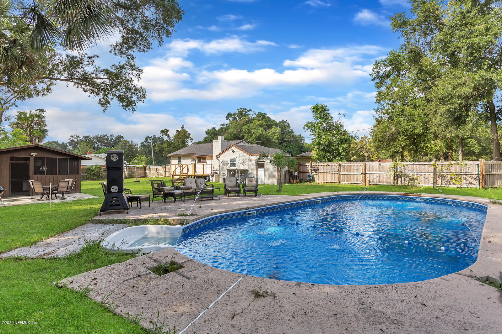 9767 Lily Road Jacksonville, FL 32246 - Photo 25 of 29 a view of a swimming pool with a patio