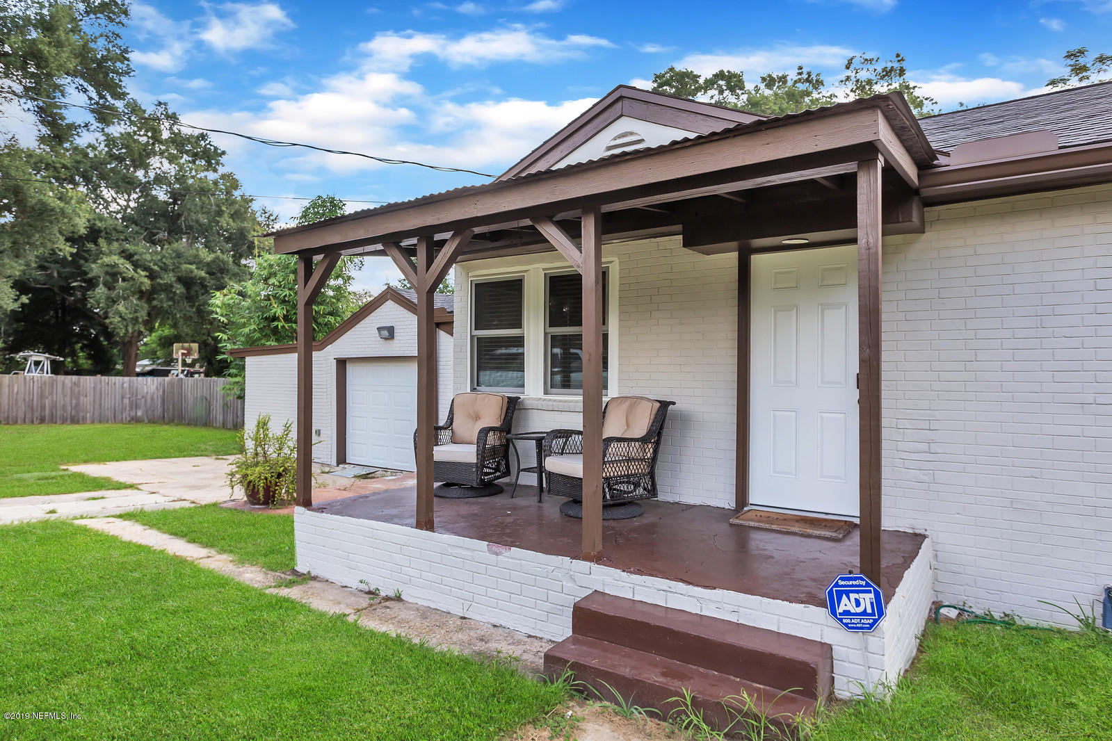 9767 Lily Road Jacksonville, FL 32246 - Photo 3 of 29 a backyard of a house with table and chairs