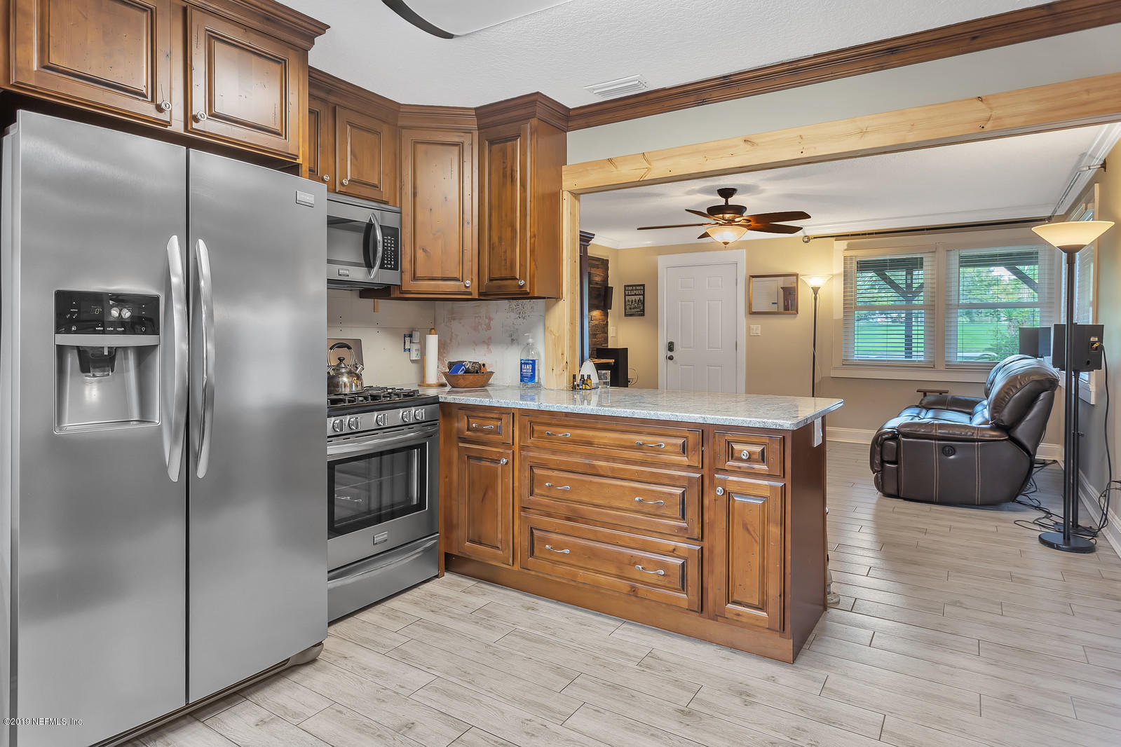 9767 Lily Road Jacksonville, FL 32246 - Photo 10 of 29 a kitchen with stainless steel appliances granite countertop a refrigerator and a stove