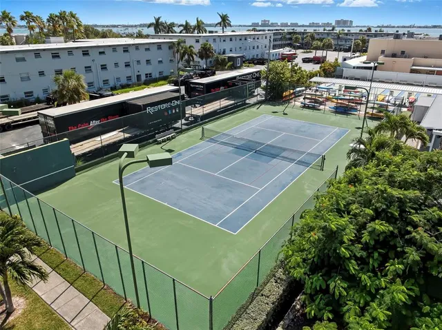 an outdoor sitting area with furniture and city view