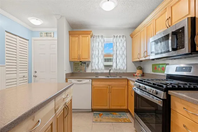 a kitchen with stainless steel appliances a stove cabinets and a counter top space