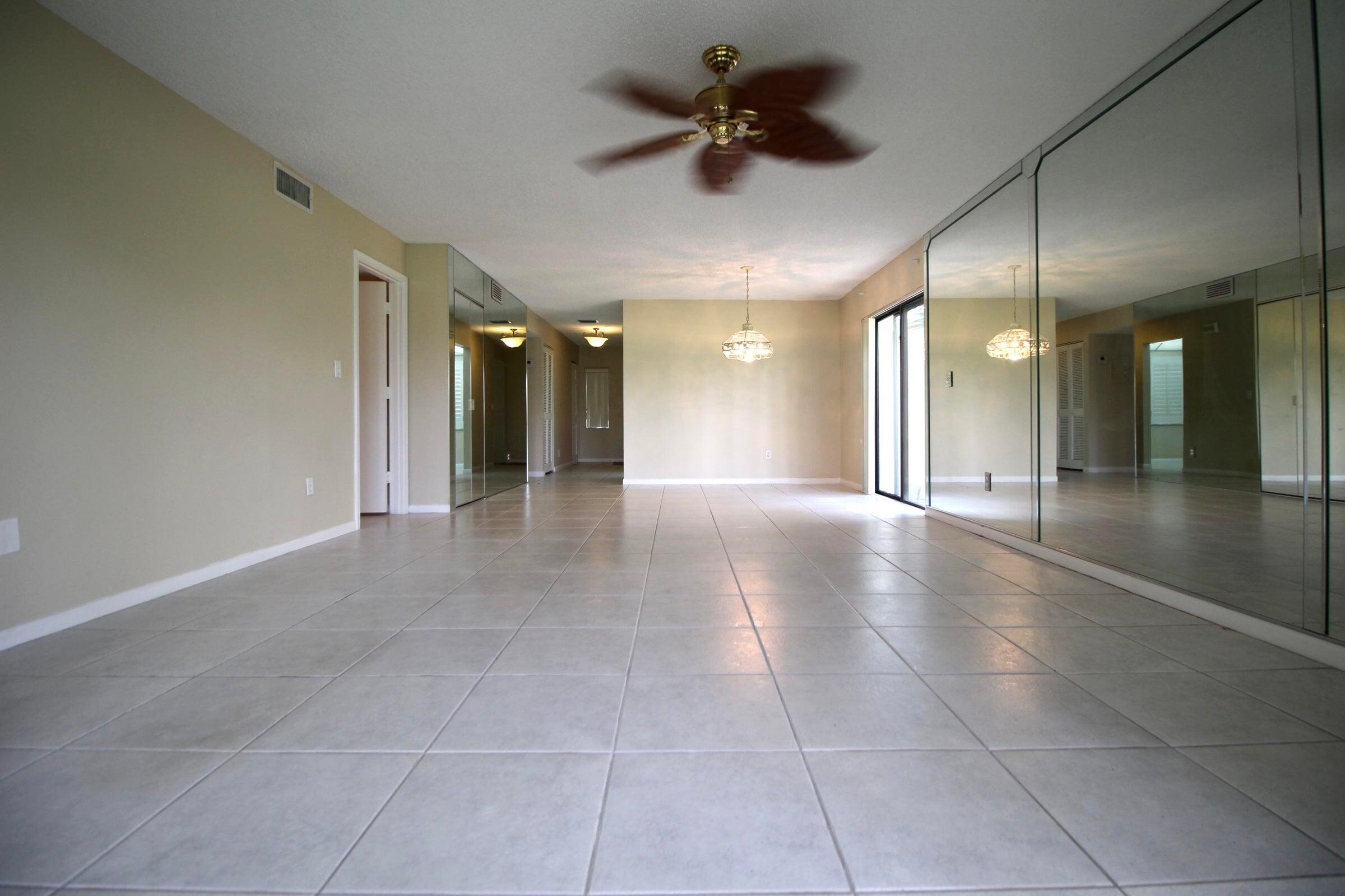 21766 Cypress Drive, Unit 20A Boca Raton, FL 33433 - Photo 18 of 21 a view of a hallway with a chandelier