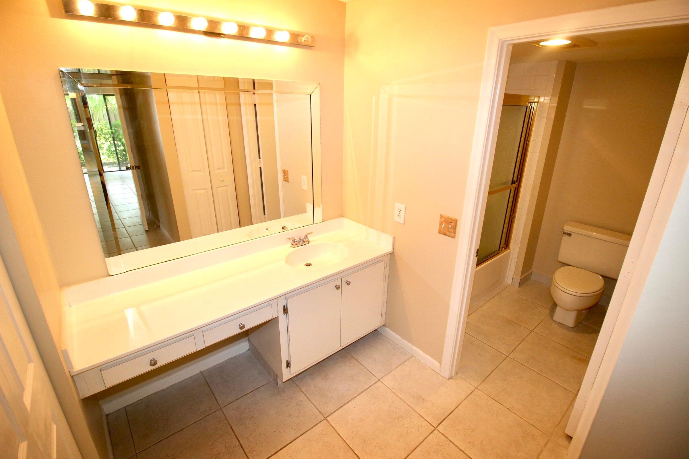 21766 Cypress Drive, Unit 20A Boca Raton, FL 33433 - Photo 5 of 21 a spacious bathroom with a double vanity sink and a mirror