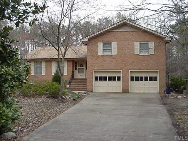4315 Randall Road Durham, NC 27707 - Photo 1 of 1 a view of a house with large windows and a small yard
