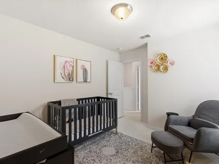 a bedroom with furniture and a window