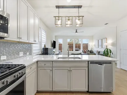 a kitchen with stainless steel appliances granite countertop a sink and cabinets