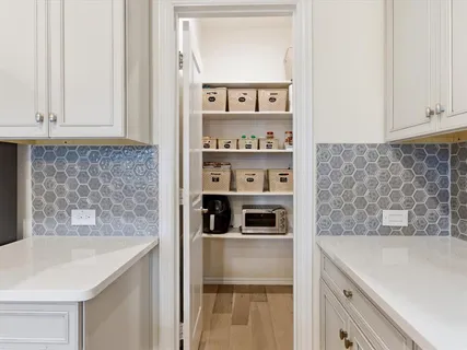 a kitchen with stainless steel appliances a sink and a refrigerator