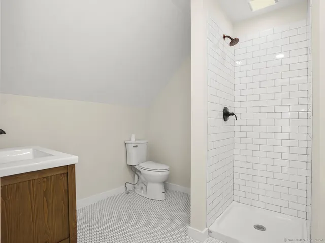 a bathroom with a shower toilet and sink