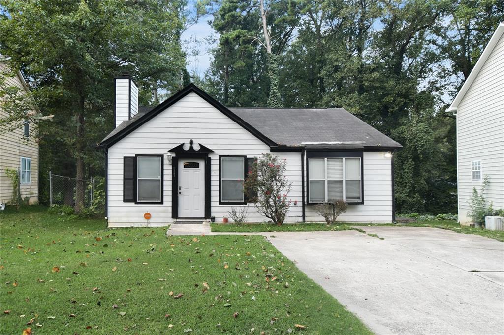 a front view of a house with a yard and porch