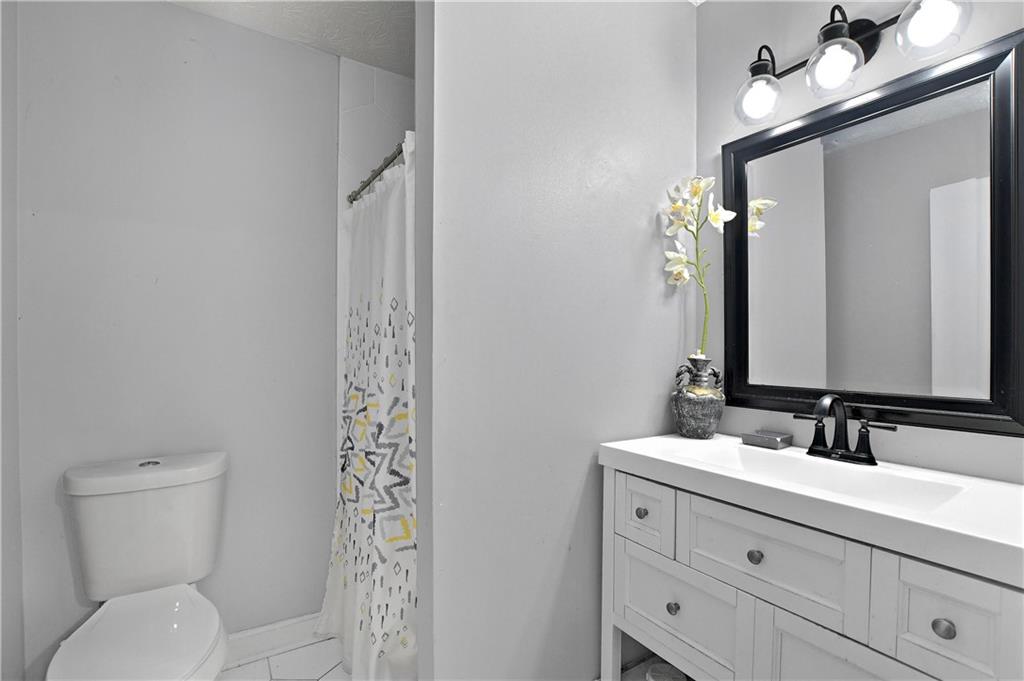 2303 Wingfoot Place Decatur, GA 30035 - Photo 9 of 10 a bathroom with a sink a toilet and shower