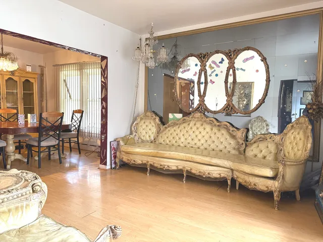 a living room with furniture a fireplace and a large mirror