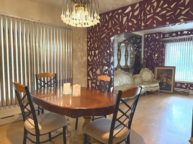 a dining room with furniture and chandelier kitchen view