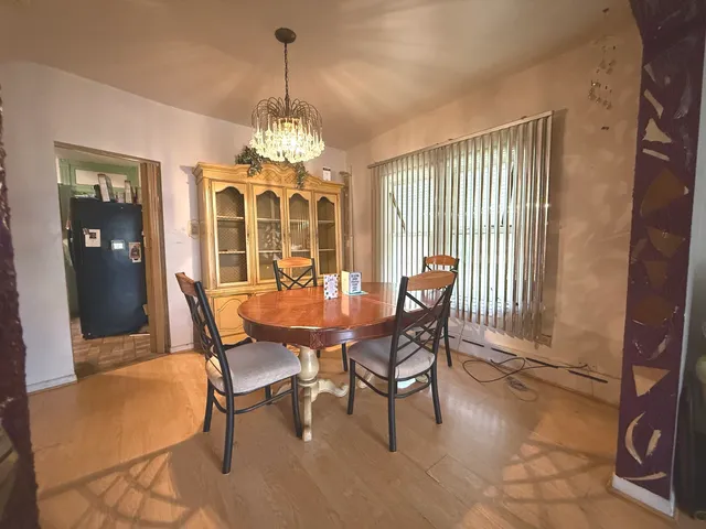 a view of a dining room with furniture and window