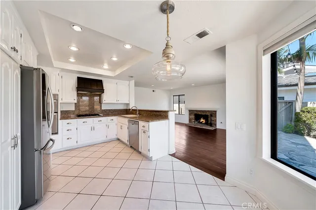 a large white kitchen with cabinets and stainless steel appliances