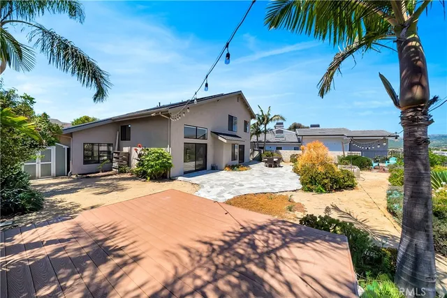 a front view of house with yard and trees around