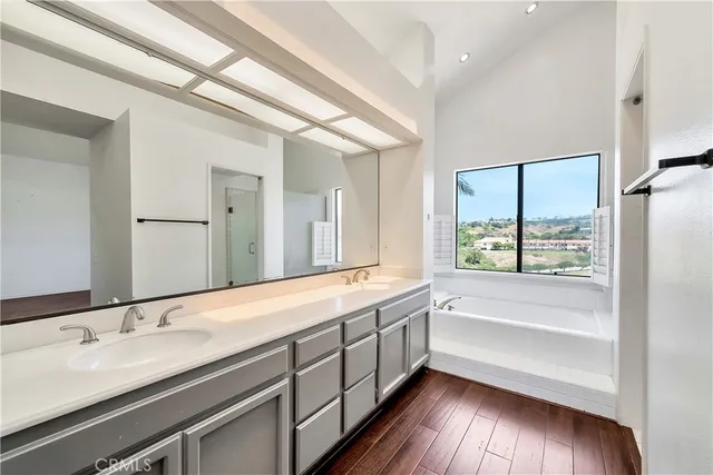 a bathroom with a double vanity sink and a large mirror