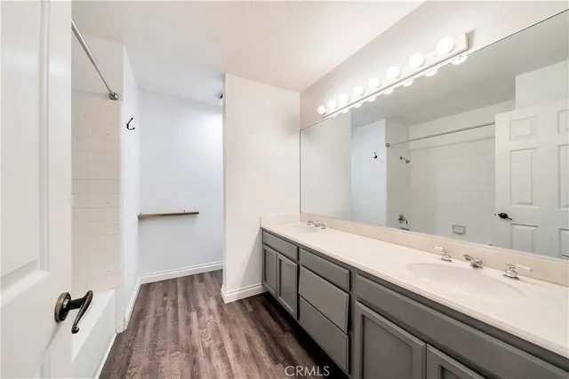 a bathroom with a double vanity sink and mirror