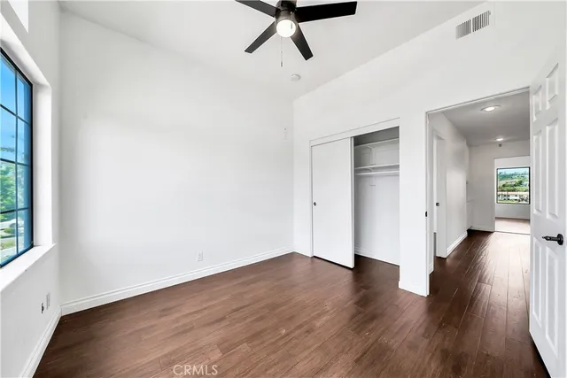 a view of a room with wooden floor and window