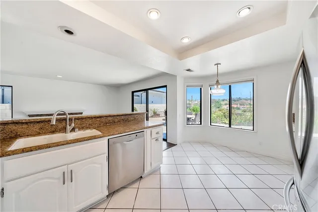 a spacious bathroom with a granite countertop sink mirror and a bathtub