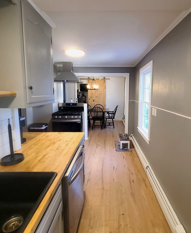 49 Anderson Avenue Middleboro, MA 02346 - Photo 9 of 25 a kitchen with a table chairs refrigerator and cabinets