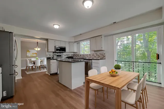 a kitchen with kitchen island a sink stove and refrigerator
