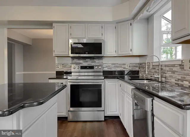 a kitchen with stainless steel appliances a refrigerator and cabinets