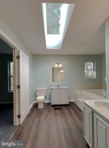 an empty room with closet and windows