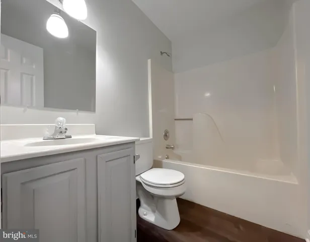 a bedroom with bed and a potted plant