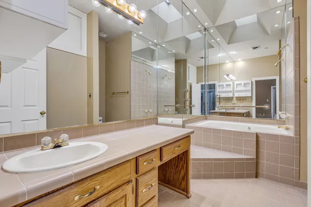 a bathroom with a sink double vanity and a mirror