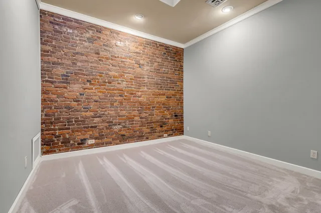 a view of an empty room and wooden floor