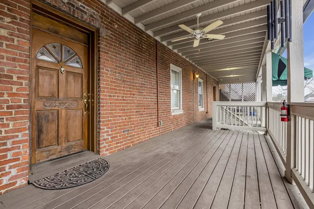a view of a porch with wooden floor and fence