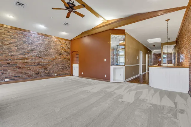 a view of a hallway with a ceiling fan