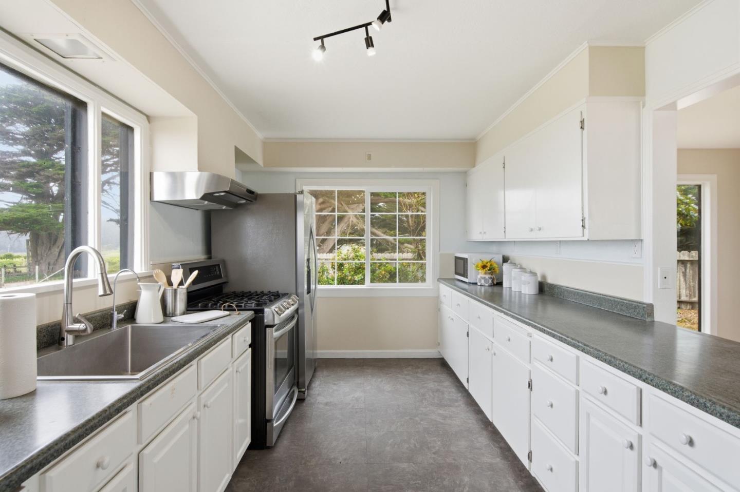 1263 Reservoir Road Pescadero, CA 94060 - Photo 16 of 66 a kitchen with granite countertop a sink and a stove top oven