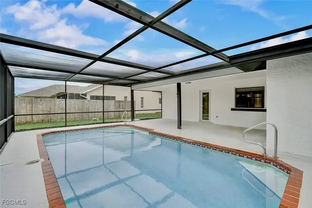 a view of a kitchen with a sink and large window