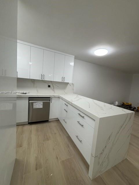 a utility room with cabinets washer and dryer