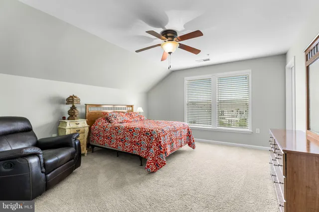 a bedroom with a bed couch and window