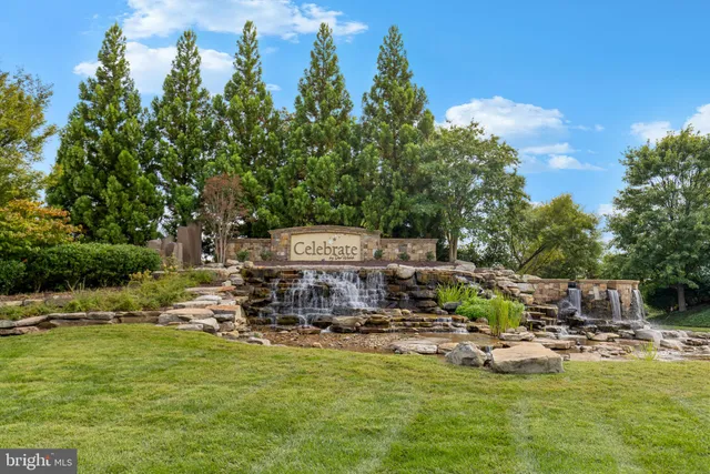 a view of a lake with a bench and trees around