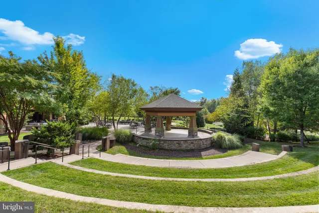 a view of a multi story residential apartment building with a yard
