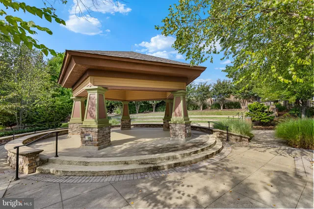 a view of backyard with a table and chairs under an umbrella