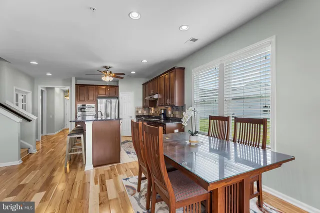 a dining room with furniture a window and kitchen view