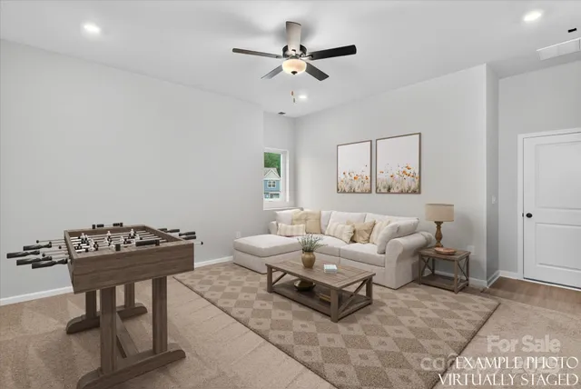 a view of an empty room with a ceiling fan