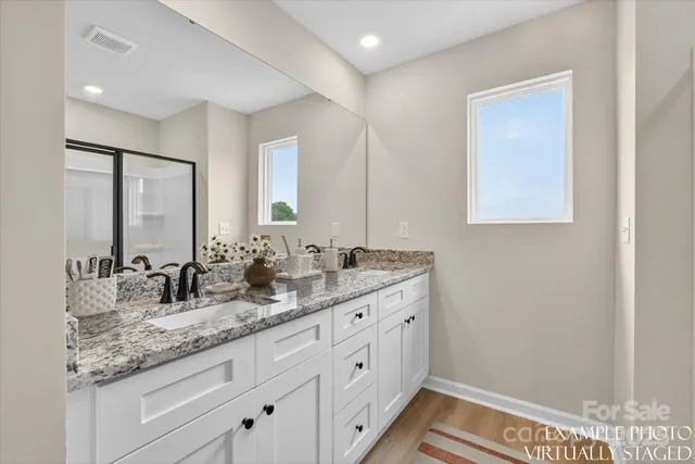 a view of a house with a yard and fence