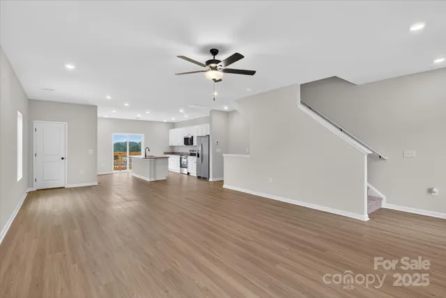 a kitchen with stainless steel appliances a dining table and chairs