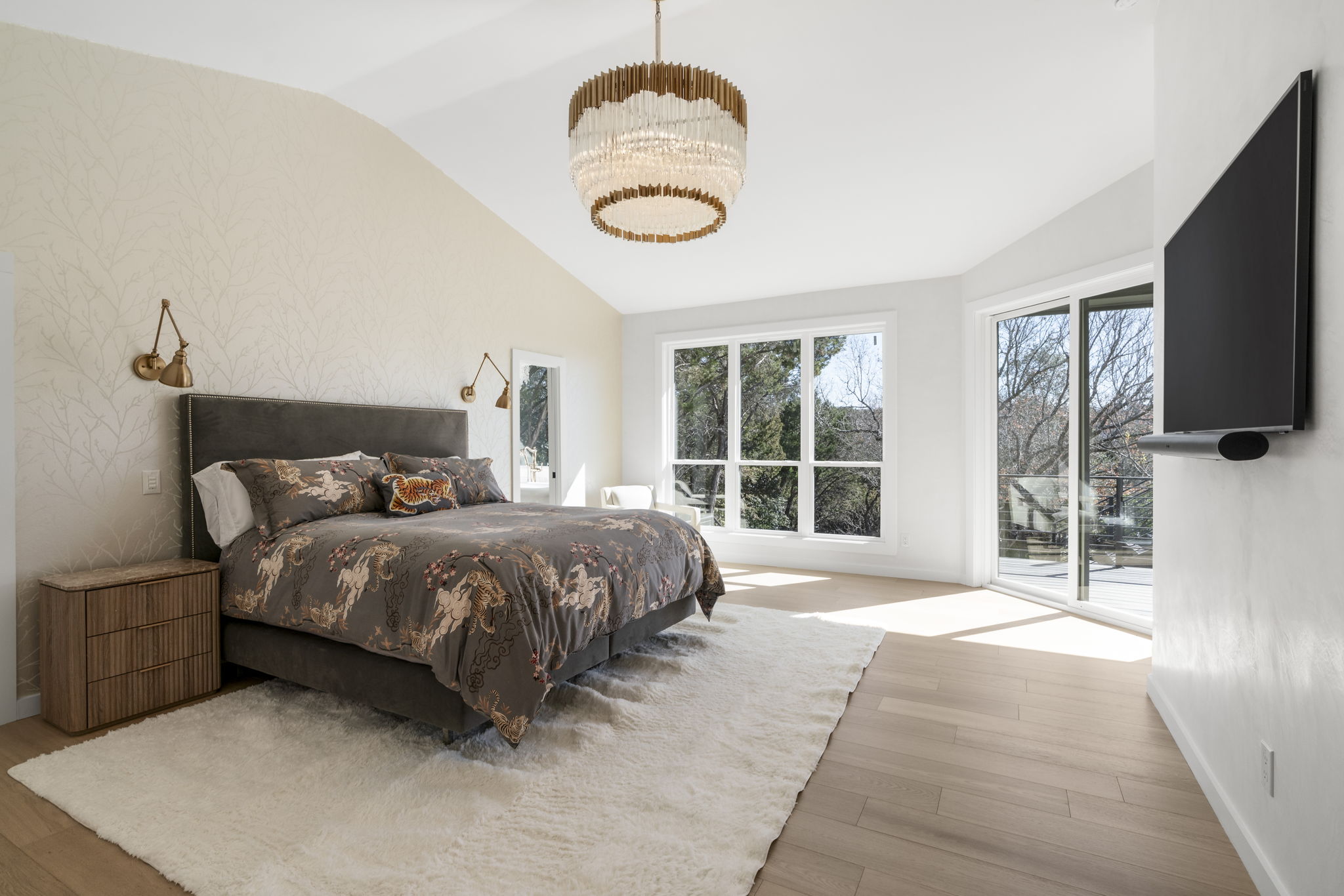 701 Furlong Drive Austin, TX 78746 - Photo 15 of 40 a spacious bedroom with a bed and a flat tv screen on the dresser