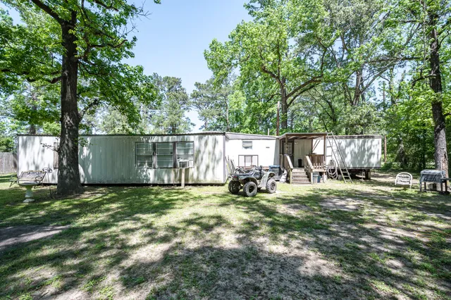 a view of a outdoor space with deck and a tree