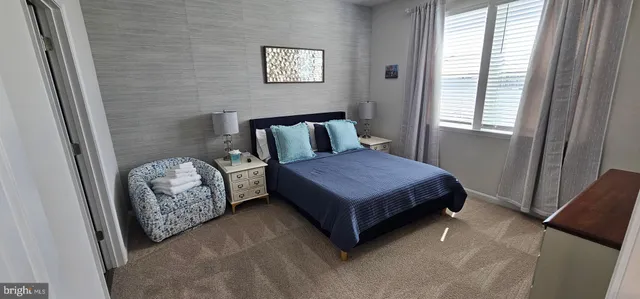 a bedroom with a bed and flat screen tv