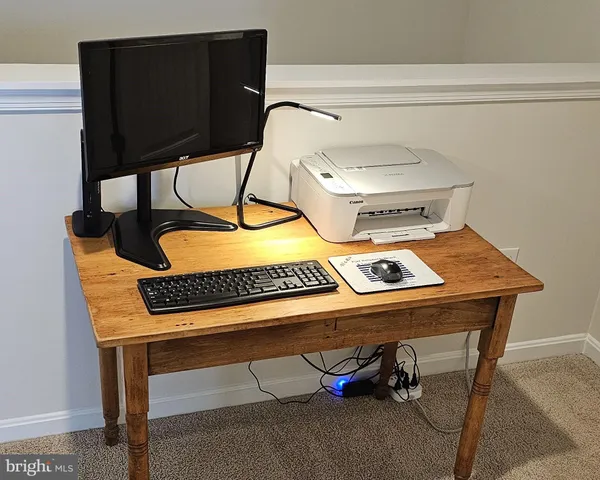 a view of a workspace with furniture