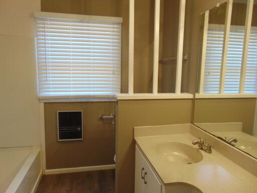 3707 24th Street Lubbock, TX 79410 - Photo 6 of 8 a bathroom with a sink and a tub