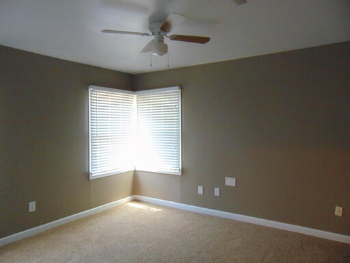 3707 24th Street Lubbock, TX 79410 - Photo 7 of 8 an empty room with a window and a ceiling fan